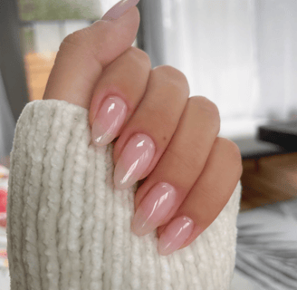 a woman's hand with neutral manicure nude manicure