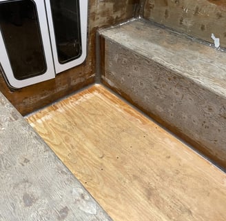staring at the companionway door, the unfinished marine plywood cockpit with thickened epoxy fillets