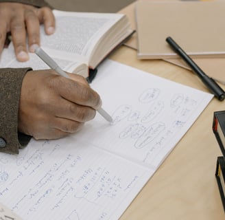 man writing notes