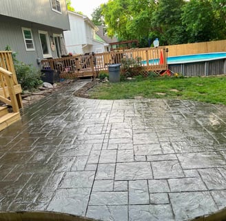 Durable stamped concrete patio in Kansas City with fire pit and outdoor furniture.