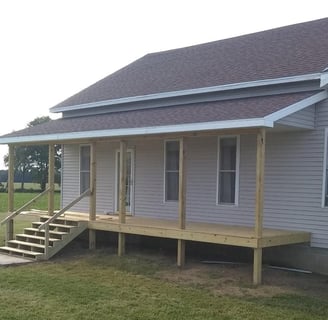 A new porch was added to this house in Goshen, IN. New shingles were fastened on the roof, as well.