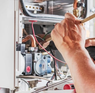 man servicing gas appliance