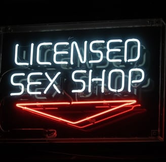neon sign that reads licensed sex shop