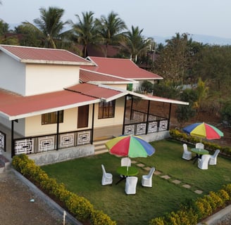 a house with umbrellas and umbrellas on a lawn