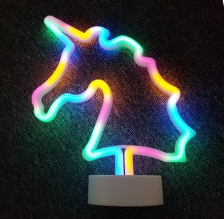 a neon - lit unicorn shaped neon - up sign