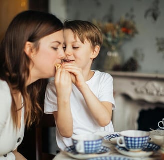 child feeding food to his mother