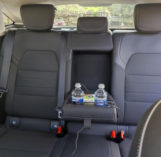 a car with a tray tray with drinks and water bottles