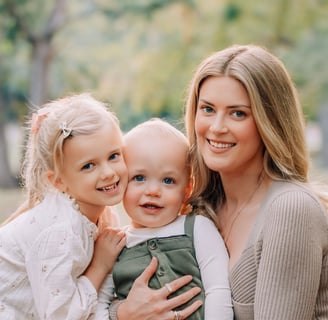 an adoption consultant woman and two young children posing for a photo