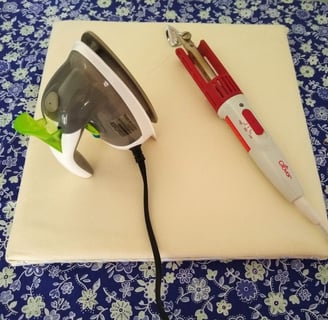 "DIY portable ironing board with a mini steam iron and a Clover craft iron resting on top, displayed