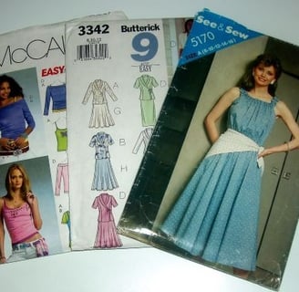 "Assorted vintage and contemporary sewing patterns including McCall's, Butterick, and See & Sew desi