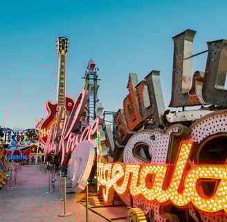 a large neon sign with a guitar in the foreground