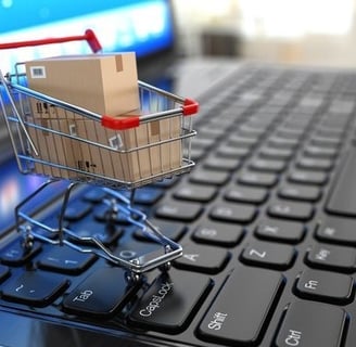 a shopping cartonce with a cartonce in front of a laptop