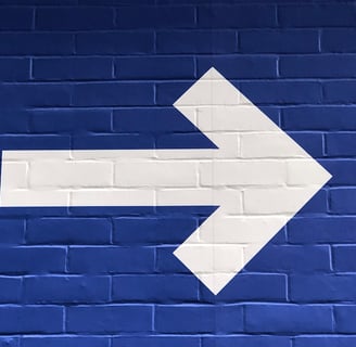 White arrow pointing right, symbolizing direction.