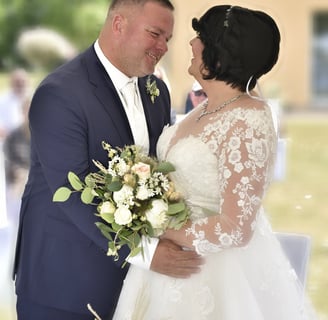 a bride and groom standing in front of a table