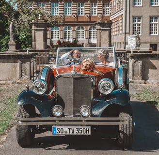 a couple of people in a car with a dog