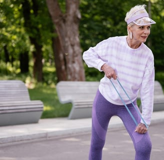 Women over 40 doing resistance band exercise for fat loss