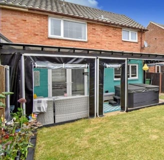 PVCFAB Aluminium pergola with heavy duty roll up all weather PVC covers and curtains in black 650g