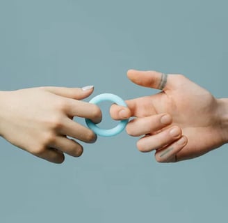 male and female hands connected by a ring