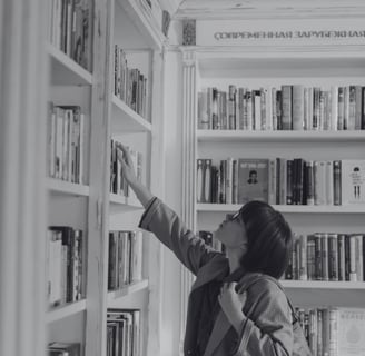 Young woman browsing books in a cozy London bookshop, carefully selecting a novel from a shelf