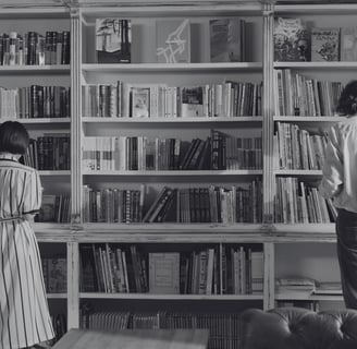 a single man and a single woman looking for books in a bookshop. 