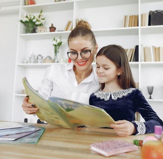 "Teacher providing guidance to a young student, ensuring clear understanding of the material."