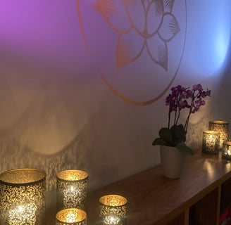 a table with candles and lit with purple light