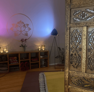 a massage space with a futon on the floor and candles