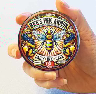 Hand holding tin of all natural tattoo aftercare product Bee's Ink Armor Daily Ink Care