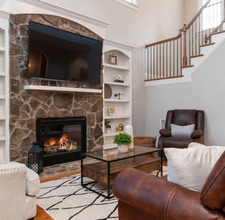 a living room with a fireplace and a tv