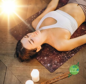 a woman is laying on a yoga mat