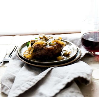 a plate of food with a glass of wine