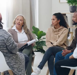 Multiple staff sitting in a mental wellness meeting