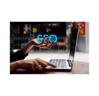 Digital marketing professional using laptop with a holographic SEO icon floating above hand