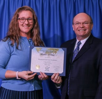 Mrs. Kori Dawson and Bro. Howard presenting VCA with Model School Status