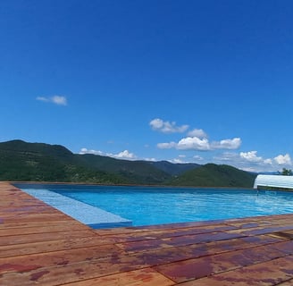 a pool with a bench and a bench in the background