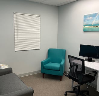 Office with chair, desk and sofa with rainbow and bridge wall art