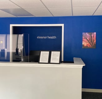 Eleanor Health front desk with tree with sunset wall art