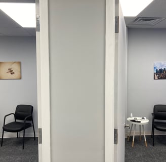 exam rooms with chairs and wall art of dragonfly and brooklyn bridge