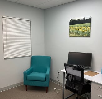 Office with office chair and desk with sunflower wall art