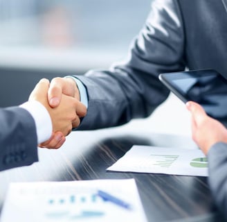 two men shaking hands with a tablet computer