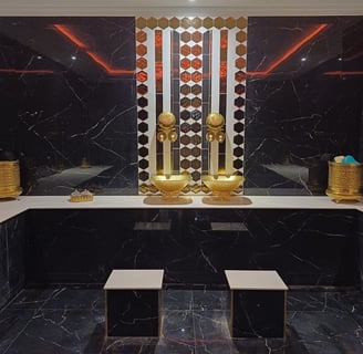 a bathroom with a mirror and a gold statue