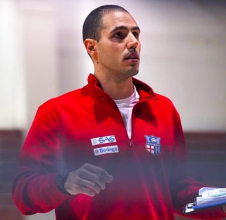 a man in a red jacket is holding a piece of paper