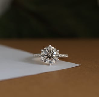 a cvd diamond ring with a cvd lab grown diamond ring on top of a paper