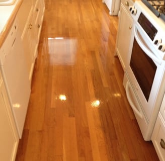 "Cleaning hardwood floors in Daytona Beach, FL in a small office kitchen by TEC Floor Services."