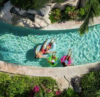 two people in swim suits are floating in a pool