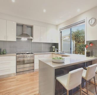 a kitchen with a large window and a table with chairs