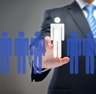 a man in a suit and tie is holding a paper cutout of a person