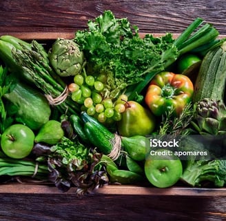 a wooden crate with vegetables and fruits on it