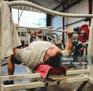 a man bench pressing some weight