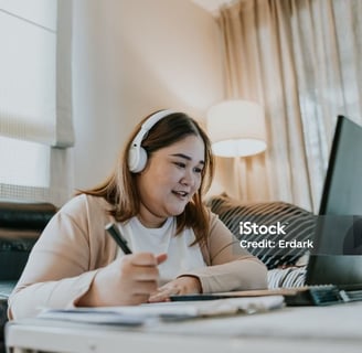 a woman sitting on a couch with headphones on her head